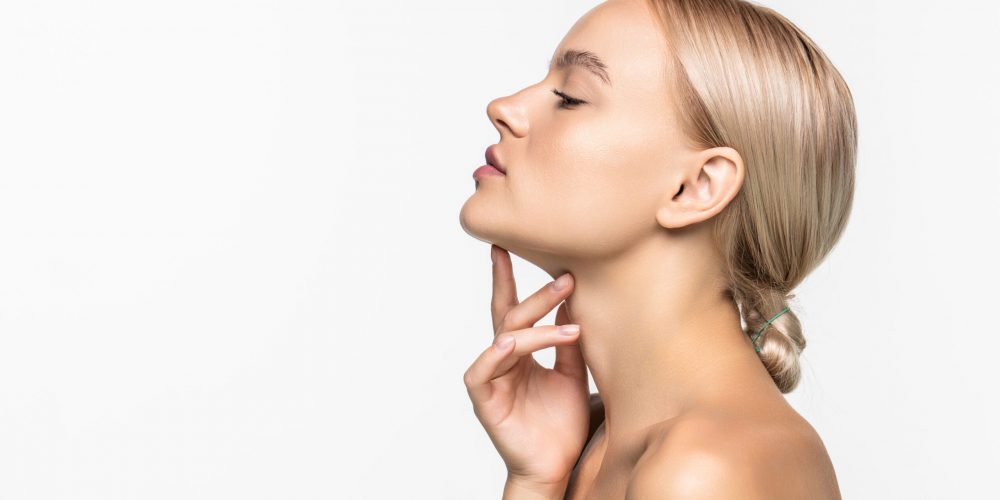Beautiful young girl touching her face. Youth and skin care concept