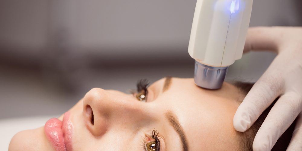 Female patient receiving cosmetic treatment at clinic